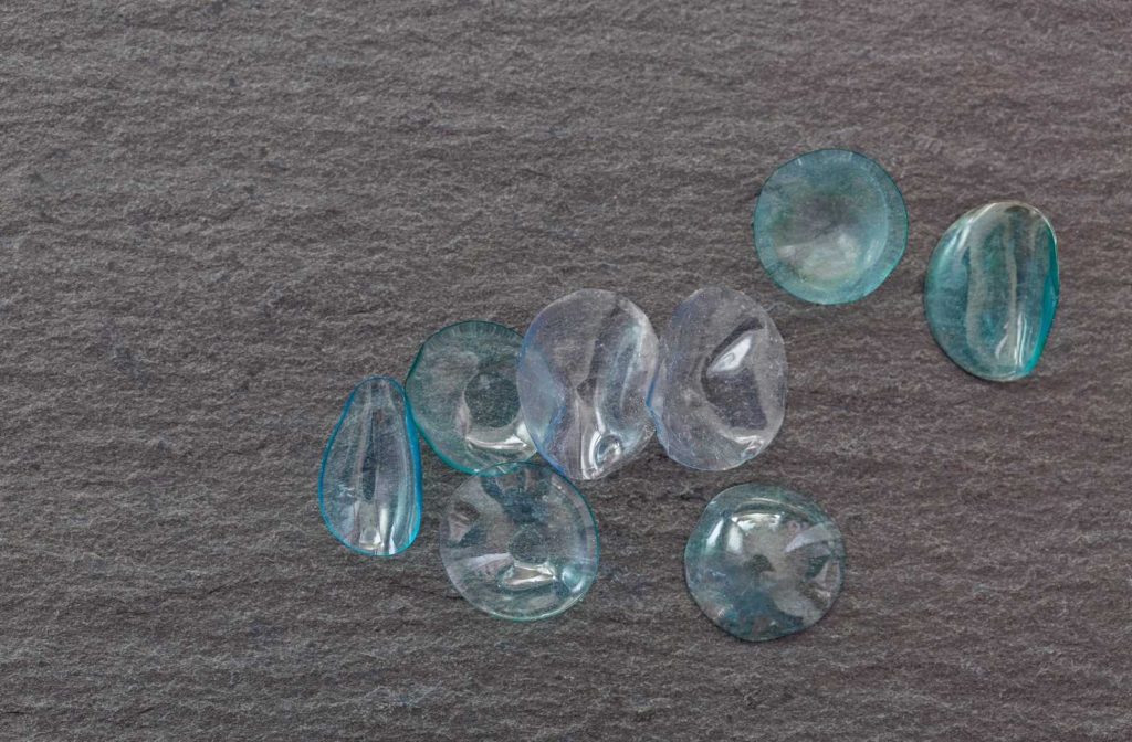 piles of dried up contact lenses on grey