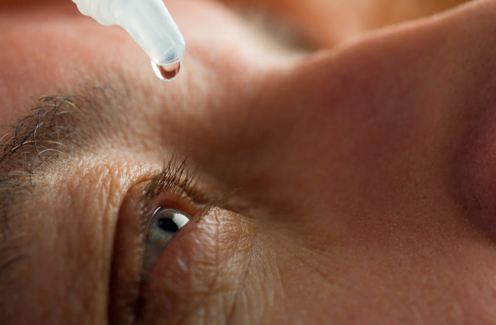 a man applies restasis drops to help with his dry eye